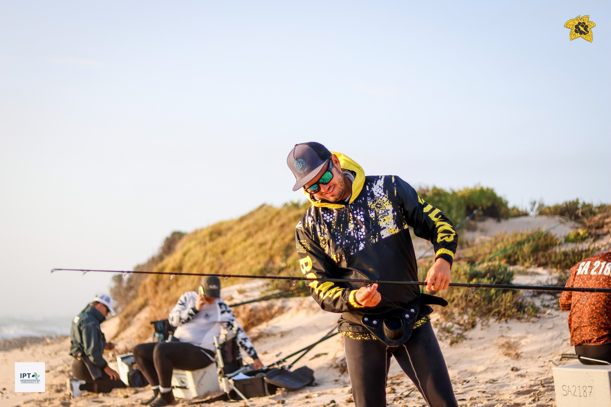 An angler preparing tackle on the beach